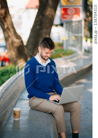 Successful Businessman in suit using tablet outdoors. Perfect for corporate, technology, and professional themes 138704315