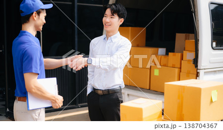 Asian Courier Delivering Package to man Delivery service near van outside the warehouse, delivery home 138704367