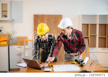 Architects and engineers collaborate on a building model, designing, planning, and measuring with teamwork, precision Architects and engineers collaborate on a building model, designing, planning, and measuring with teamwork, precision 138704571