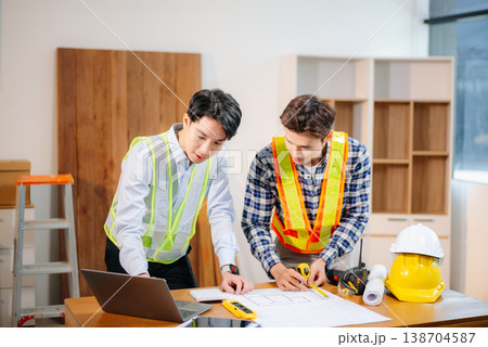 Engineer teams meeting working together wear worker helmets hardhat with on architectural project site and making model house. Engineer teams meeting working together wear worker helmets hardhat with on architectural project site and making model house. 138704587