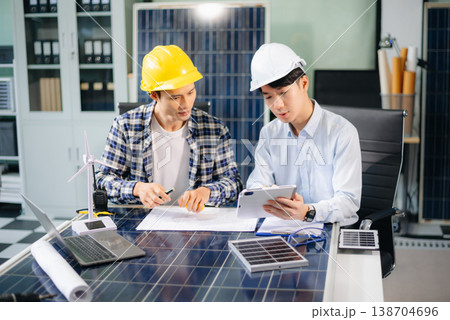 Business people having consultation about wind energy at company office. Business team discussing about windmill and alternative green energy. Business people having consultation about wind energy at company office. Business team discussing about windmill and alternative green energy. 138704696