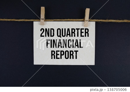 2nd Quarter Financial Report text written on paper card with rope and wooden clip hanging 2nd Quarter Financial Report text written on paper card with rope and wooden clip hanging 138705006