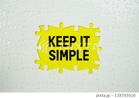 Jigsaw puzzle with a missing piece with "Keep It Simple" on yellow background 138705010