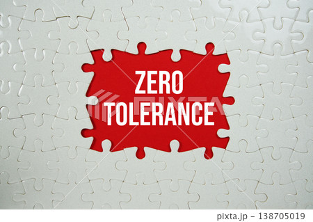 Jigsaw puzzle with a missing piece with "Zero Tolerance" on red background Jigsaw puzzle with a missing piece with "Zero Tolerance" on red background 138705019