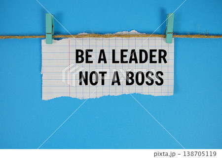 Be A Leader Not A Boss text written on rip paper with wooden clip on blue background 138705119