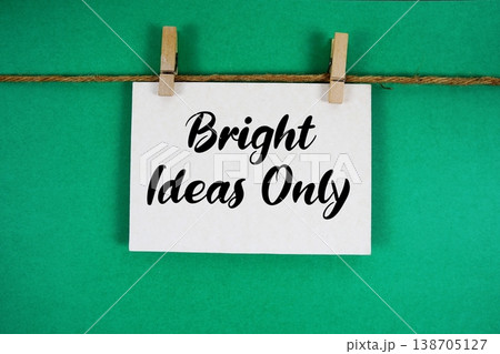 Bright Ideas Only text written on paper card with rope and wooden clip hanging Bright Ideas Only text written on paper card with rope and wooden clip hanging 138705127