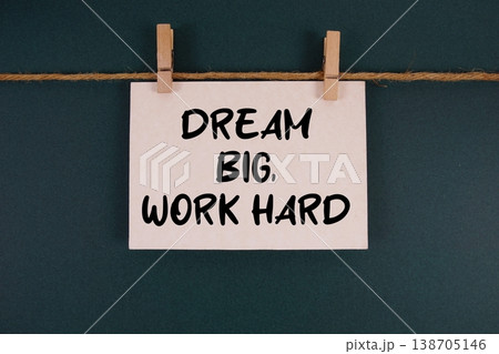 Dream Big, Work Hard text written on paper card with rope and wooden clip hanging 138705146