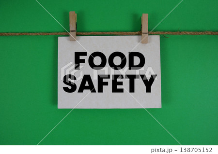 Food Safety text written on paper card with rope and wooden clip hanging Food Safety text written on paper card with rope and wooden clip hanging 138705152