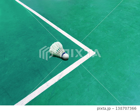 A white badminton shuttlecock is placed on the badminton court. A white badminton shuttlecock is placed on the badminton court. 138707366