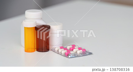 Various medicine bottles and blister packs on a white surface 138708316