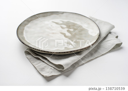 An empty grey textured plate on a white table An empty grey textured plate on a white table 138710539