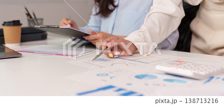 Team collaboration on financial analysis in office 138713216