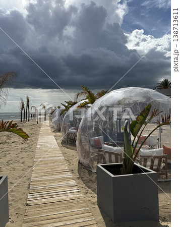 Clear beachside domes and wooden path under dramatic sky create a unique scenery background 138713611