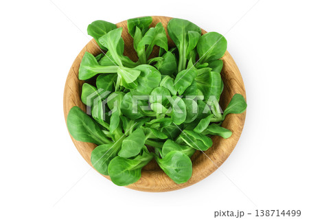 Valerian leaves salad. Corn salad in wooden bowl isolated on white backgrounds. Lettuce salad. Top view 138714499