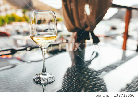 A glass of white wine on the table. A glass of white wine on the table. 138715656