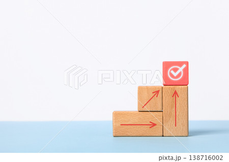 Business growth success achievement concept. Wooden blocks in form of graphical steps up and arrows of business growth process, sustainable financial plan. Action plan, profit, economic concepts 138716002