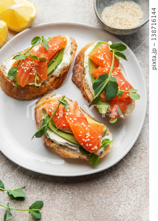 Salmon avocado bruschetta with cream cheese and lemon 138716144