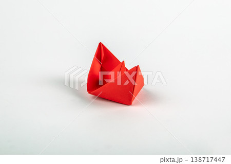 Single Red Origami Paper Boat on Minimal Light Background Single Red Origami Paper Boat on Minimal Light Background 138717447