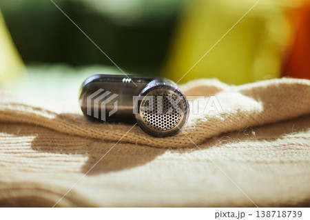 Black Fabric Shaver Removing Lint from Knitted Sweater 138718739