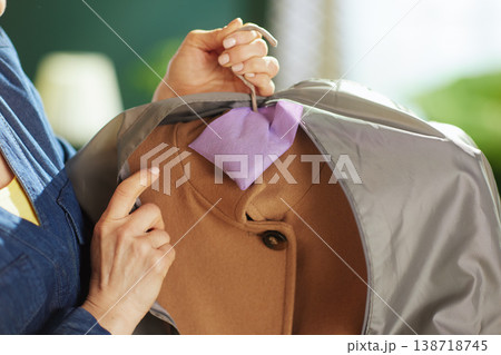 Adding Lavender Sachet to Winter Coat in Garment Bag Adding Lavender Sachet to Winter Coat in Garment Bag 138718745