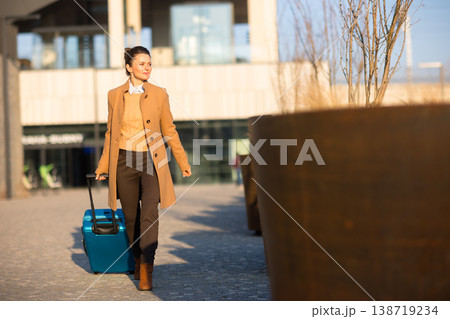 Smiling Woman Arriving at a Modern Train Station 138719234