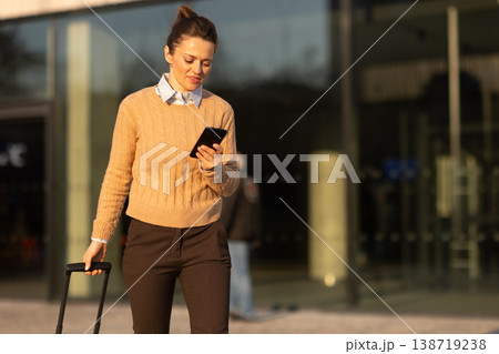 Connected Traveler Walking Through Modern Transit Hub 138719238
