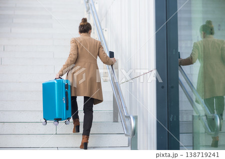 Rear View of Woman with Luggage at Railway Station Rear View of Woman with Luggage at Railway Station 138719241