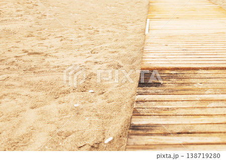 Wooden walkway leading along sandy beach 138719280