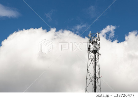 Bottom perspective pov of modern metal steel mobile 5g network wireless telecom tower against clear blue sky background on bright day. Microwave signal broadband equipment base line station mast 138720477
