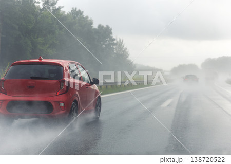 Back tail view of many cars driving fast on wet highway road after rain in Europe. Automobile accident vehicle rush hour collapse. Transportation vacation seasonal stuck. Low visibility bad weather 138720522