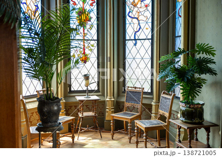Historic Interior Room With Stained Glass Windows Antique Chairs And Decorative Plants 138721005