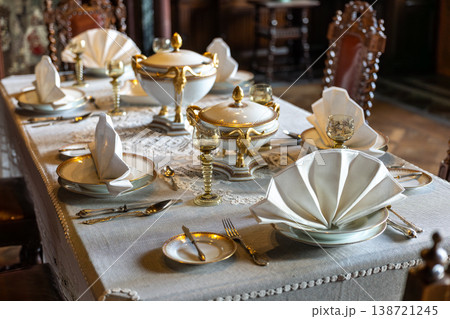 Elegant Antique Dining Table Setting With Porcelain Dishes Linen Napkins And Classic Interior 138721245