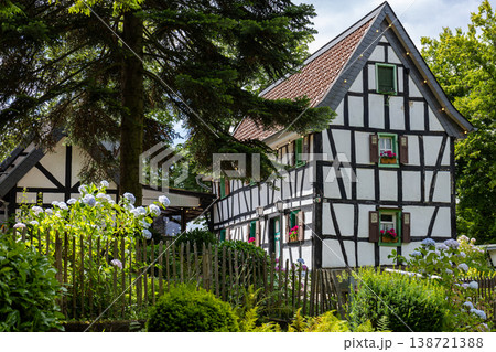 Traditional Half Timbered European House Exterior With Garden And Summer Greenery Traditional Half Timbered European House Exterior With Garden And Summer Greenery 138721388
