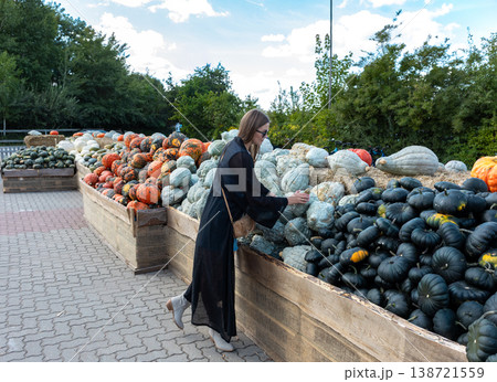 Young Woman Choosing Pumpkin At Autumn Farm Market Harvest Festival Lifestyle Outdoor Scene 138721559