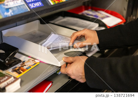 Close Up Of Hands Sorting Mail And Documents At Office Reception Counter Close Up Of Hands Sorting Mail And Documents At Office Reception Counter 138721694