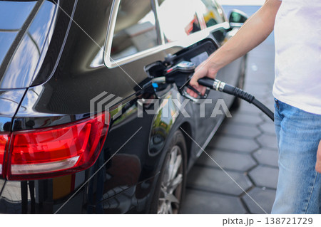 Close Up Of Fuel Nozzle Refueling Modern Car At Gas Station Transportation Energy Concept Close Up Of Fuel Nozzle Refueling Modern Car At Gas Station Transportation Energy Concept 138721729