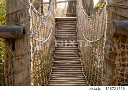 Rustic Wooden Suspension Bridge with Rope Rails Adventure, Connection and Growth Concept 138721766