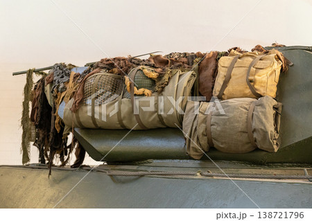 Military Equipment Storage On Armored Tank With Camouflage Net Backpack And Field Gear Military Equipment Storage On Armored Tank With Camouflage Net Backpack And Field Gear 138721796