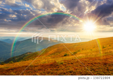 sunset over nature scenery with alpine meadow. carpathian mountain landscape during summertime. stunning view of rolling hills. cloudy sky with rainbow. highland background for freedom concept 138722804