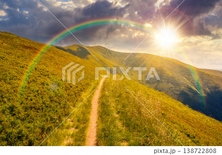 sunset over nature scenery with alpine meadow. carpathian mountain landscape during summertime. stunning view of rolling hills. cloudy sky with rainbow. highland background for freedom concept 138722808