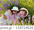 Mother and daughter relaxing in lavender field, summer family lifestyle 138724626