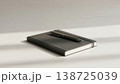 Minimalist presentation of journal and pen on plain surface 138725039