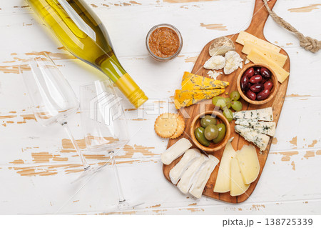 Cheese board with assorted cheeses and olives Cheese board with assorted cheeses and olives 138725339