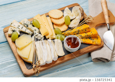 Cheese board with olives grapes and honey 138725341