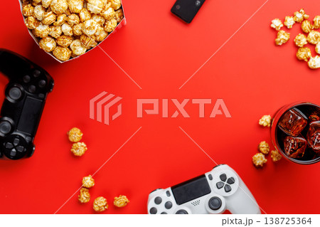 Popcorn, cola and gamepad on red background Popcorn, cola and gamepad on red background 138725364
