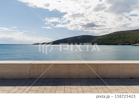 Riverwalk along the sea with mountains on the horizon 138725423