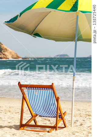 Beach loungers and umbrella by the sea 138725440