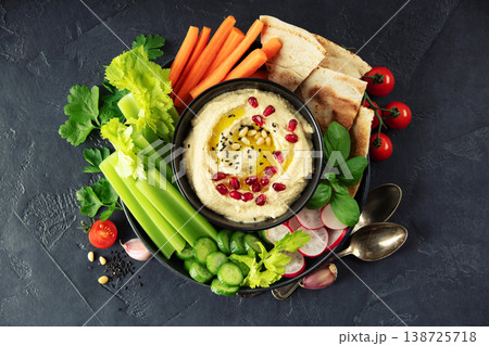Fresh Hummus Platter with Vegetables and Pita on Dark Background 138725718