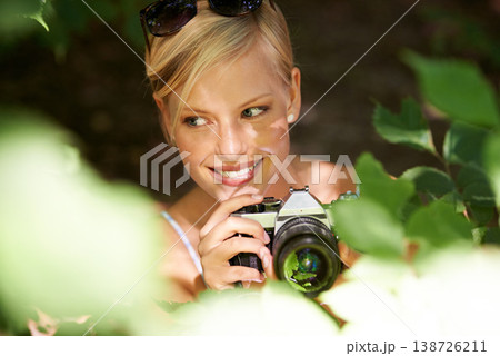 Smile, photographer and nature with woman in forest for trees, environment and relax. Shooting, camera lens and photography with face of female person in woods for travel, torusim and summer Smile, photographer and nature with woman in forest for trees, environment and relax. Shooting, camera lens and photography with face of female person in woods for travel, torusim and summer 138726211