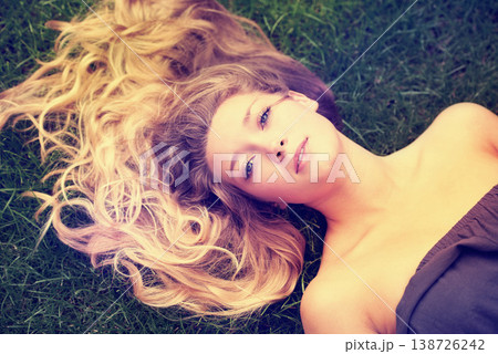 Portrait, hair and a woman on the grass from above to relax in nature during summer for freedom. Face, beauty and a girl in the park, lying on a field outdoor to rest on a green background alone Portrait, hair and a woman on the grass from above to relax in nature during summer for freedom. Face, beauty and a girl in the park, lying on a field outdoor to rest on a green background alone 138726242